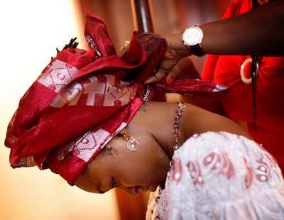 African bride tying hair