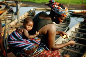 African mother working with child on back